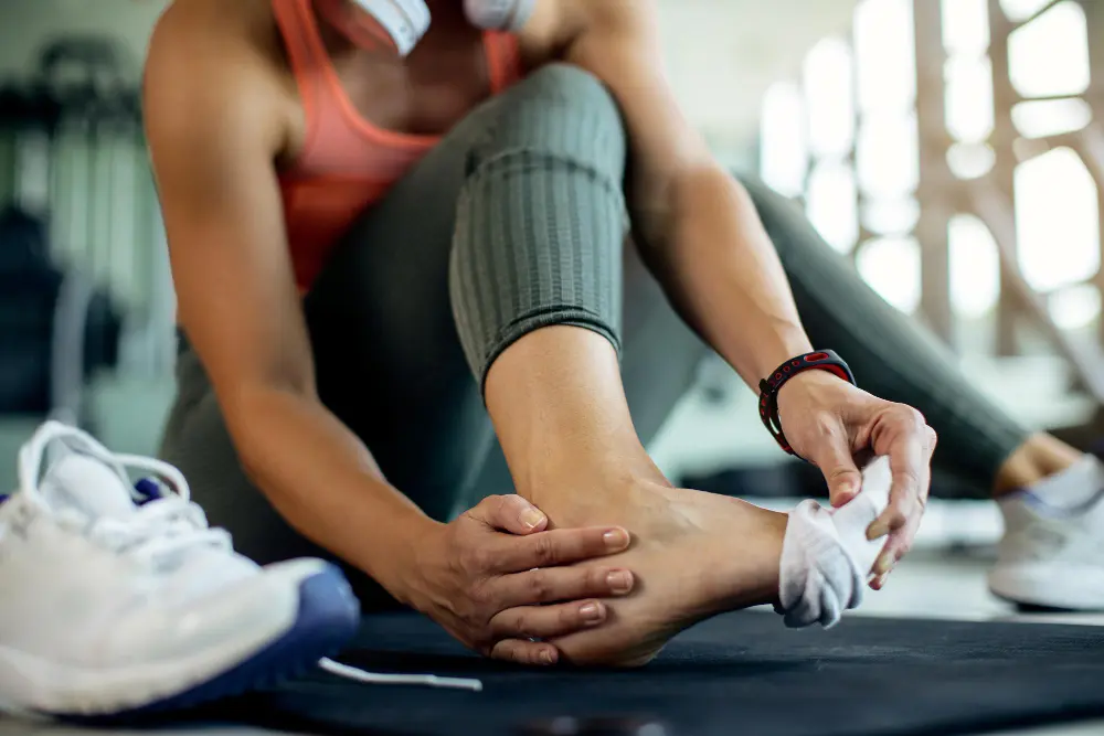 female athlete holding leg after minor sports injury