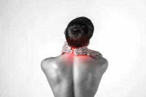 Person waking up with neck pain after sleeping in poor position