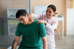 Person experiencing pinched nerve pain in neck and lower back